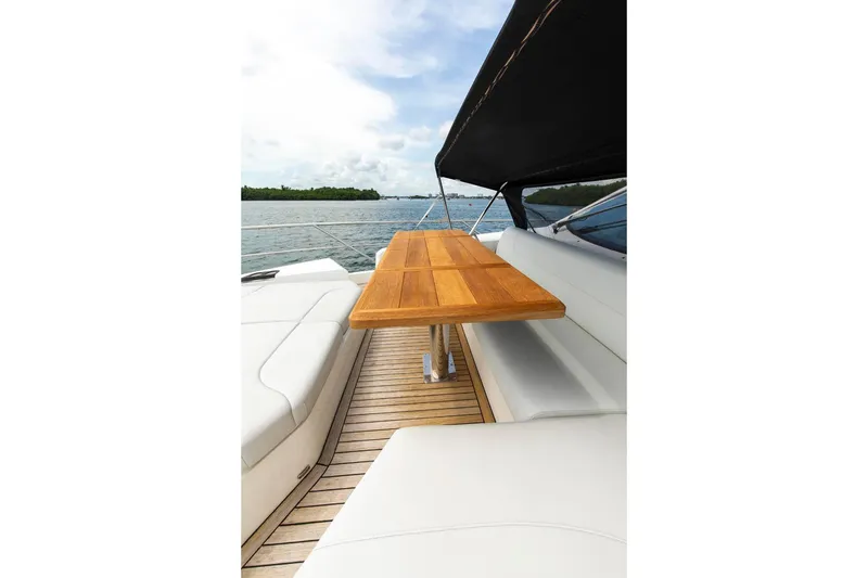 Slide: The Image of Luxurious Sunseeker Manhattan 68 yacht deck with wooden table, 2021 model. - 88