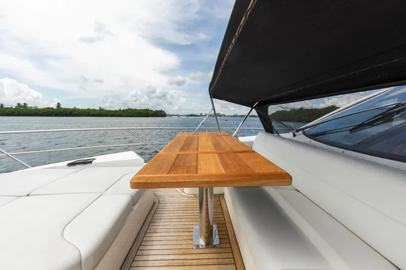 Slide: The Image of Luxurious Sunseeker Manhattan 68 yacht deck with wooden table, 2021 model. - 89