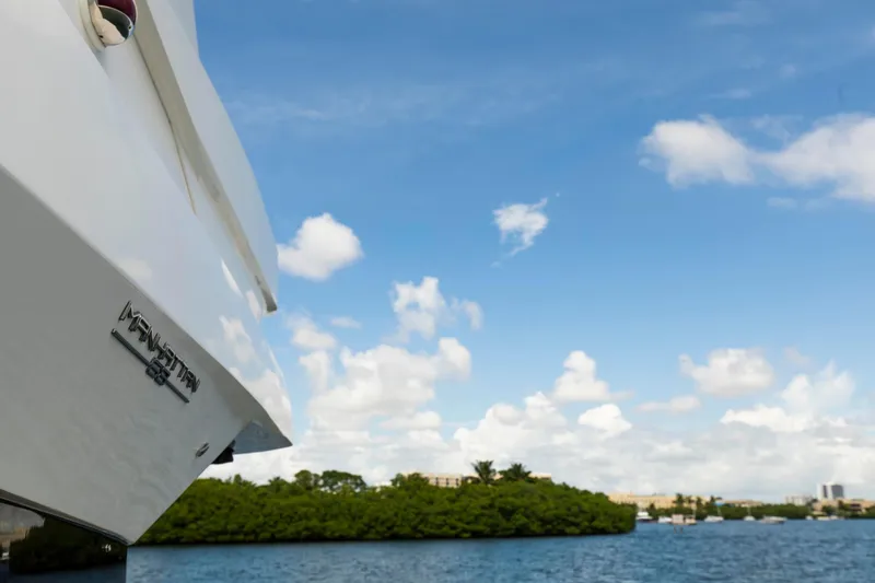 Slide: The Image of Sunseeker Manhattan 68 yacht on serene water with blue sky, 2021 model. - 93