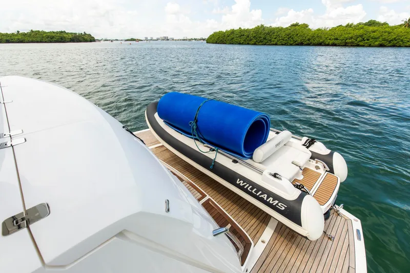 Slide: The Image of Sunseeker Manhattan 68 yacht with Williams tender on deck, 2021 model, scenic water view. - 97