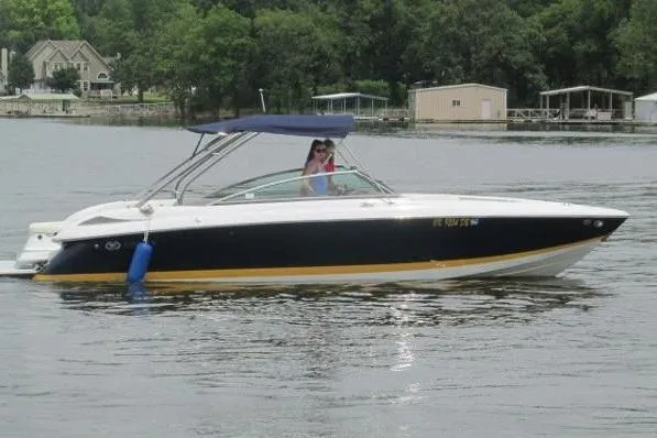 The Image of 2006 Cobalt 272 boat on a lake with trees and docks in the background. - 0
