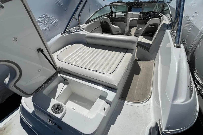 Slide: The Image of 2006 Cobalt 272 boat interior with open storage compartment and seating area. - 11