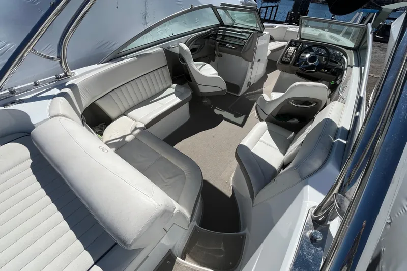 Slide: The Image of Interior of a 2006 Cobalt 272 boat with white leather seating and modern dashboard. - 12
