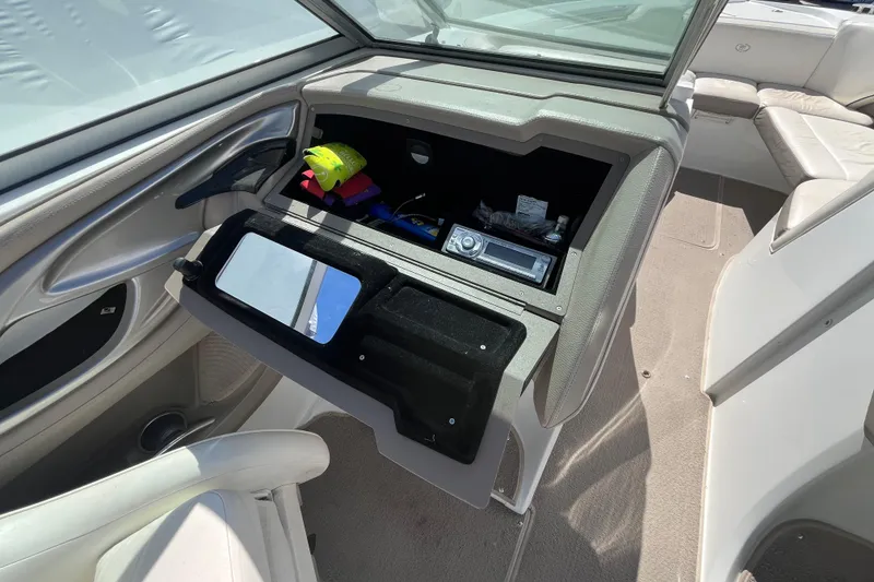 Slide: The Image of 2006 Cobalt 272 boat interior with open glove compartment and stereo system. - 16