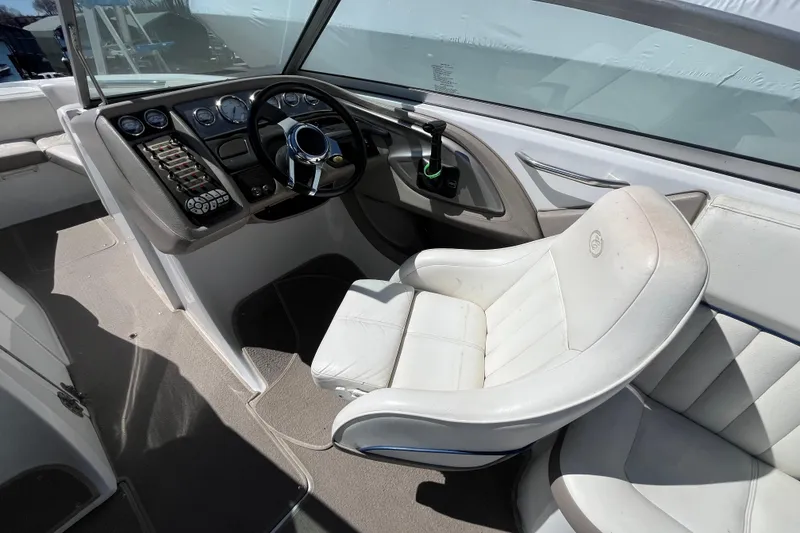 Slide: The Image of 2006 Cobalt 272 boat interior with steering wheel and white captain's chair. - 18