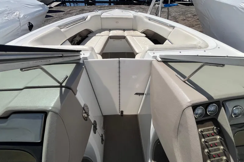 Slide: The Image of 2006 Cobalt 272 boat interior with white seating and dashboard controls. - 21