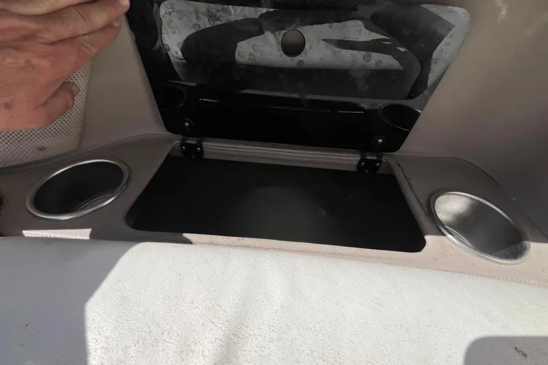 Slide: The Image of 2006 Cobalt 272 boat interior with cup holders and storage compartment. - 22