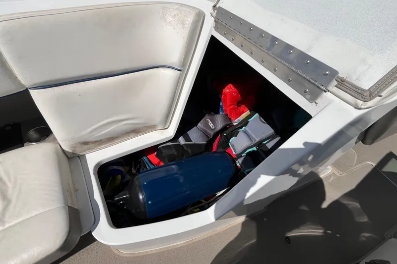Slide: The Image of Storage compartment in a 2006 Cobalt 272 boat with life jackets and equipment. - 23