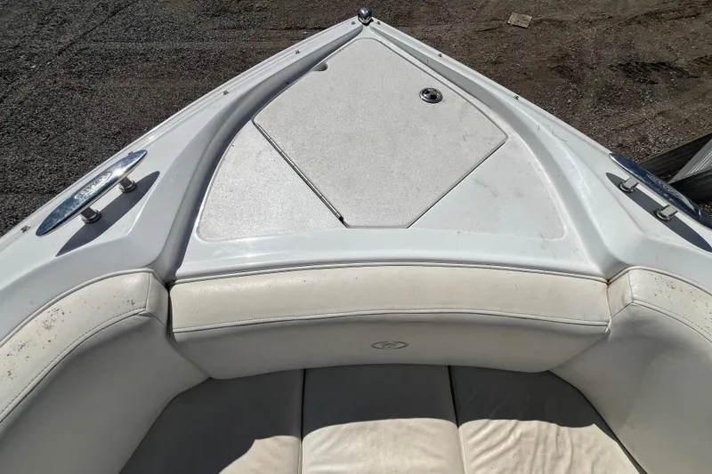 Slide: The Image of Bow seating area of a 2006 Cobalt 272 boat with white upholstery. - 24