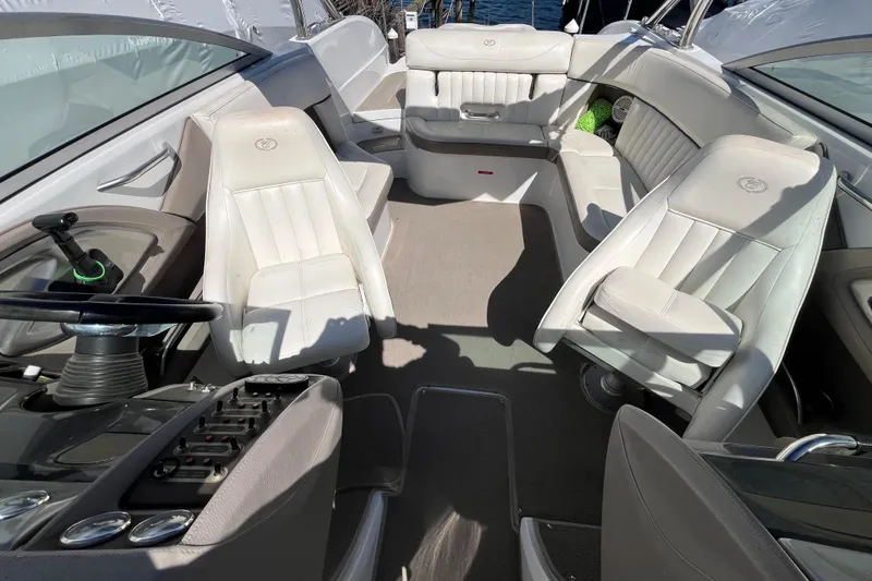 Slide: The Image of Interior of a 2006 Cobalt 272 boat with white leather seating and steering console. - 28