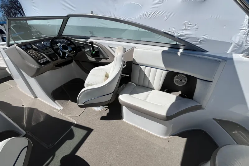 Slide: The Image of Interior of a 2006 Cobalt 272 boat featuring steering wheel and seating area. - 29