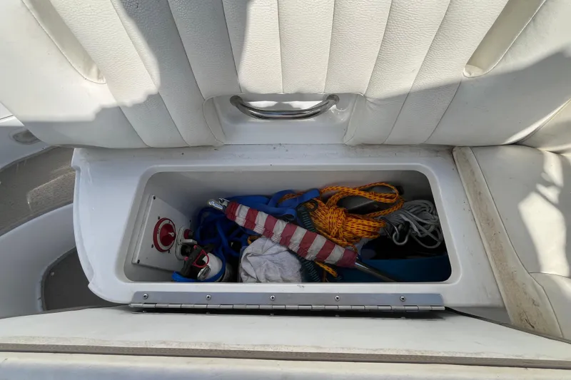 Slide: The Image of Storage compartment in a 2006 Cobalt 272 boat with ropes and equipment. - 31