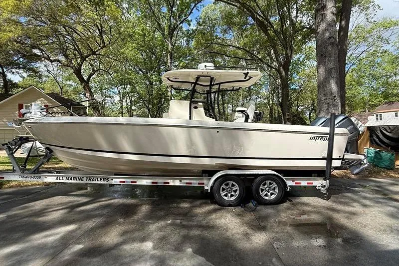 The Image of 2003 Intrepid 289 Center Console boat on trailer, parked outdoors. - 0