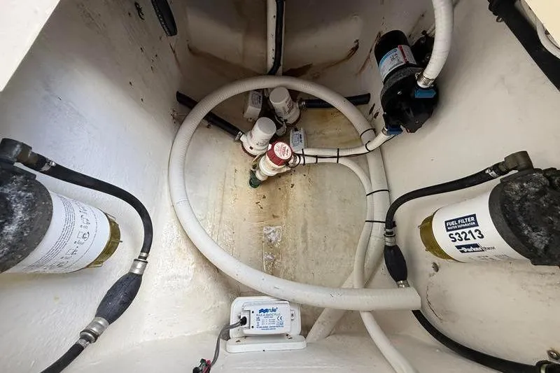 Slide: The Image of Bilge area of a 2003 Intrepid 289 Center Console with fuel filters and hoses. - 11