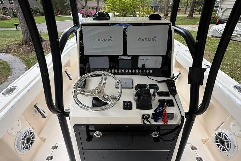 Slide: The Image of 2003 Intrepid 289 Center Console boat dashboard with Garmin navigation systems. - 14