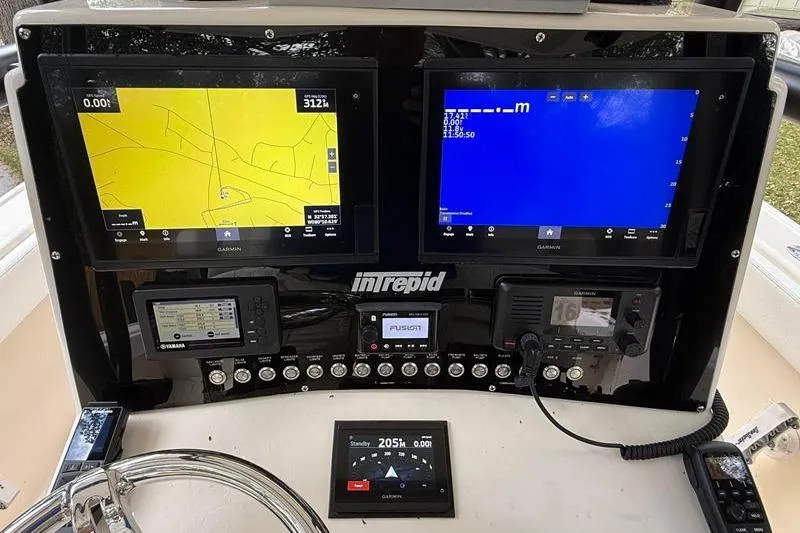 Slide: The Image of Dashboard of a 2003 Intrepid 289 Center Console with navigation screens and controls. - 15