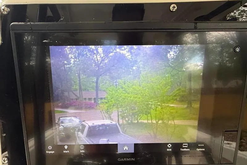 Slide: The Image of Garmin display on 2003 Intrepid 289 Center Console showing outdoor view with trees and vehicles. - 20