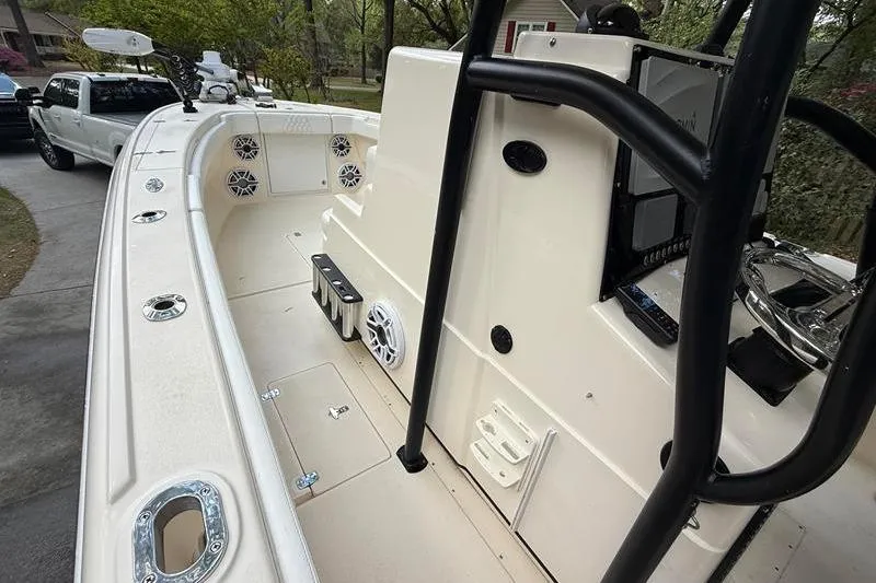 Slide: The Image of 2003 Intrepid 289 Center Console boat interior with speakers and steering console. - 24