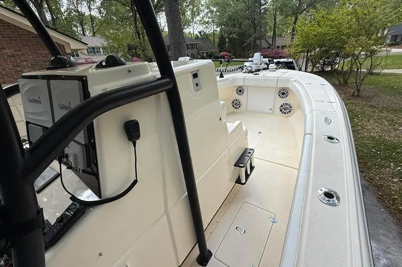 Slide: The Image of 2003 Intrepid 289 Center Console boat with Garmin electronics, parked outdoors. - 25
