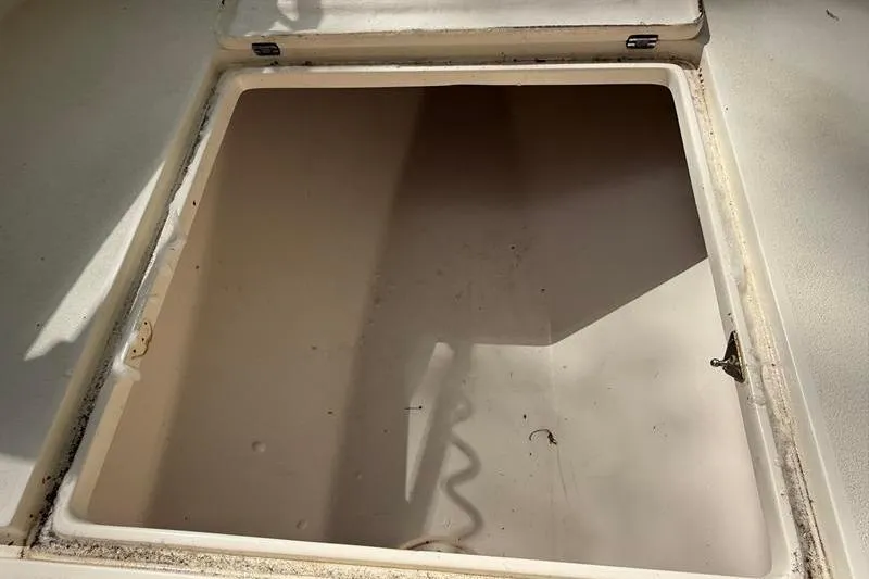 Slide: The Image of Open storage compartment on a 2003 Intrepid 289 Center Console boat. - 28