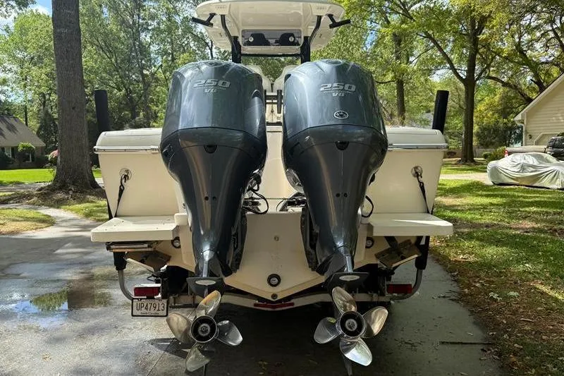 Slide: The Image of 2003 Intrepid 289 Center Console with dual 250 HP outboard engines, parked outdoors. - 3