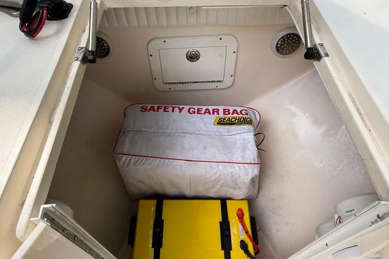 Slide: The Image of Storage compartment of a 2003 Intrepid 289 Center Console with safety gear bag and equipment. - 32