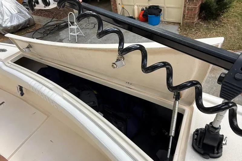 Slide: The Image of Open storage compartment on a 2003 Intrepid 289 Center Console boat, showing equipment inside. - 36