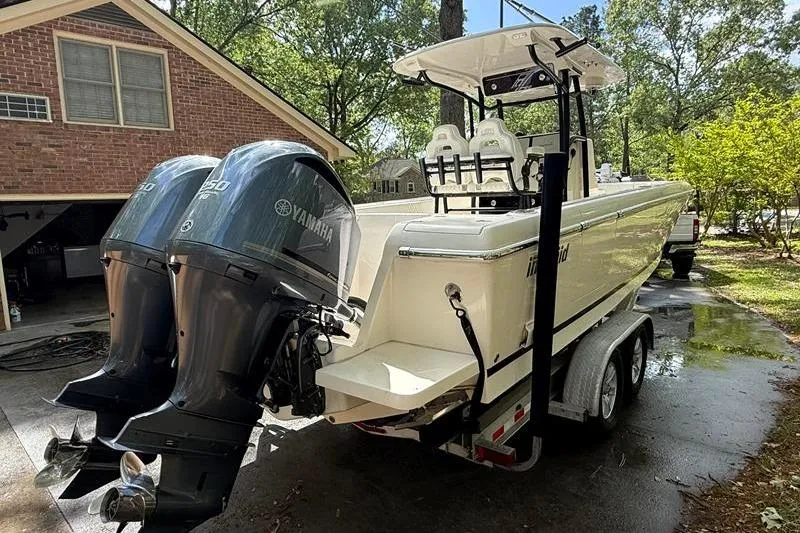 Slide: The Image of 2003 Intrepid 289 Center Console boat with dual Yamaha engines on a trailer. - 4