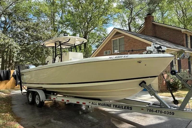 Slide: The Image of 2003 Intrepid 289 Center Console boat on trailer in residential driveway. - 6