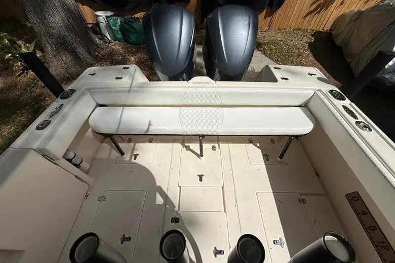 Slide: The Image of 2003 Intrepid 289 Center Console boat interior with dual engines and seating area. - 9