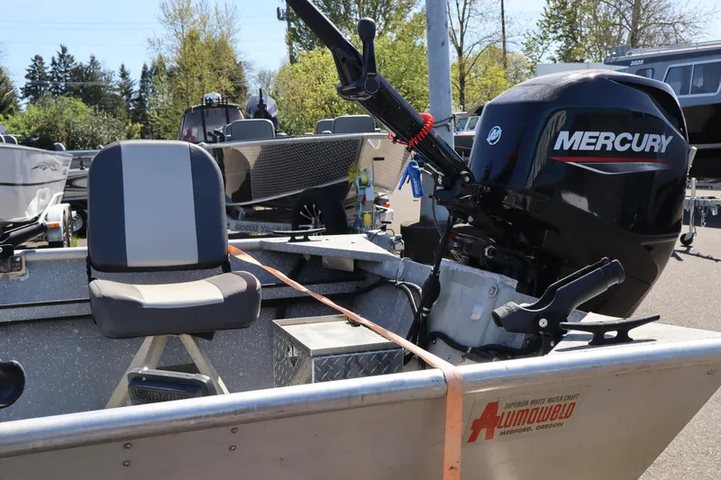 Slide: The Image of 1978 Alumaweld Flatbottom boat with Mercury outboard motor, parked outdoors. - 10