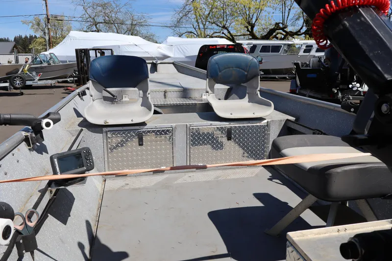 Slide: The Image of 1978 Alumaweld Flatbottom boat interior with seats and equipment, parked outdoors. - 11