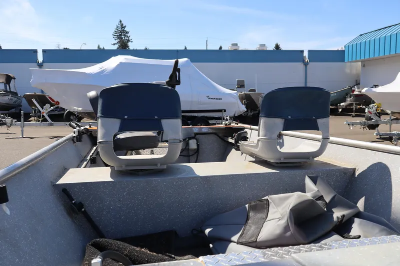 Slide: The Image of 1978 Alumaweld Flatbottom boat interior with two seats, parked in a marina. - 13