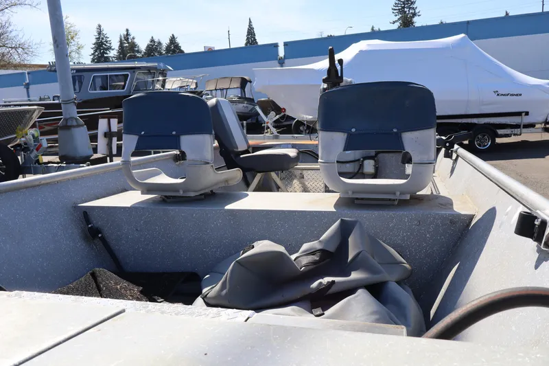 Slide: The Image of 1978 Alumaweld Flatbottom boat interior with two seats and covered equipment. - 14