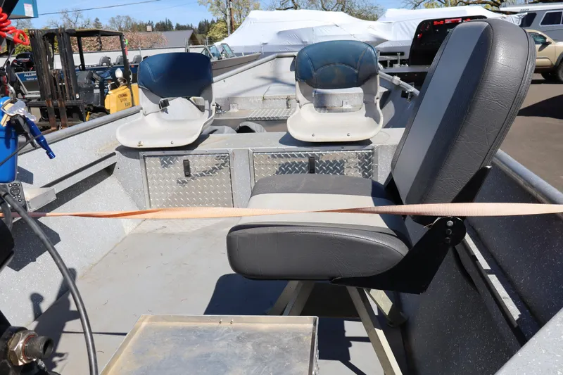 Slide: The Image of 1978 Alumaweld Flatbottom boat interior with seating and equipment, parked outdoors. - 17