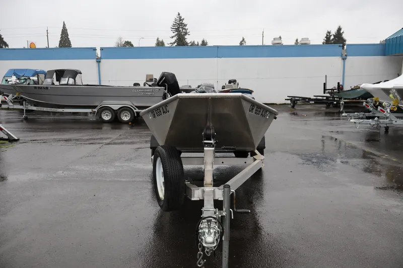 Slide: The Image of 1978 Alumaweld Flatbottom boat on trailer in a wet parking lot. - 2