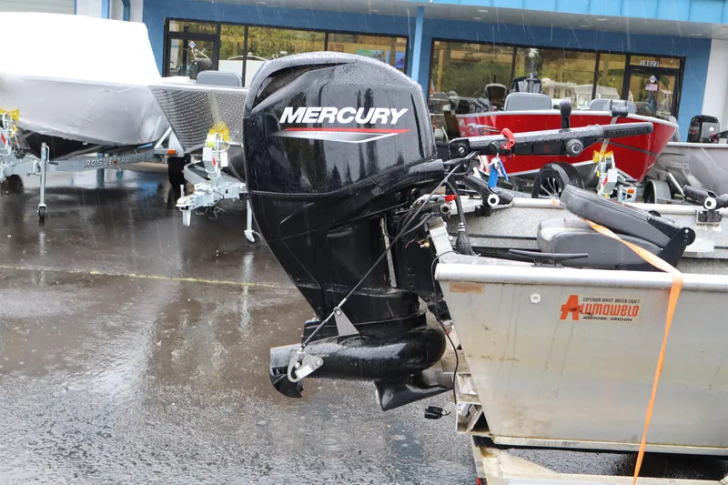 Slide: The Image of 1978 Alumaweld Flatbottom boat with Mercury outboard motor in a dealership lot. - 4