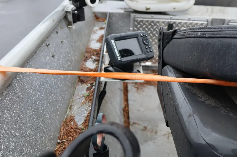 Slide: The Image of 1978 Alumaweld Flatbottom boat interior with fish finder and orange strap. - 7