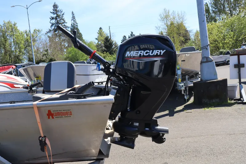 Slide: The Image of 1978 Alumaweld Flatbottom boat with Mercury outboard motor in a sunny outdoor setting. - 9
