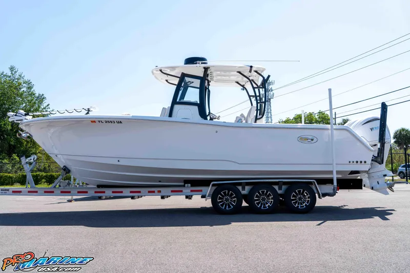 The Image of 2025 Sea Hunt Gamefish 28 Forward Seating boat on trailer, side view. - 0