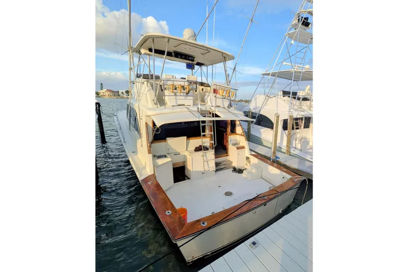 Slide: The Image of 1985 Ocean Yachts 55 Super Sport docked, showcasing spacious deck and flybridge. - 44