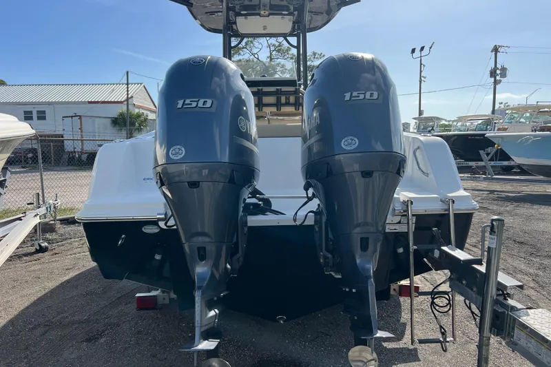 Slide: The Image of 2017 Sportsman Heritage 251 Center Console with twin Yamaha 150 engines, parked outdoors. - 3