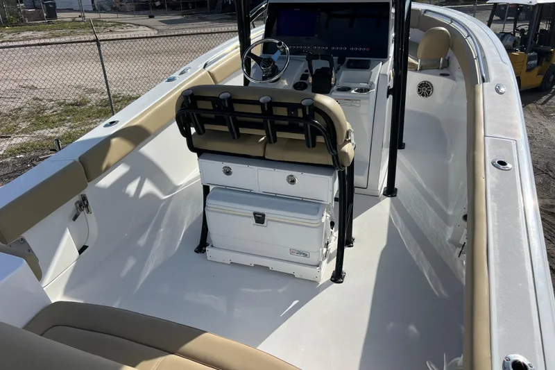 Slide: The Image of 2017 Sportsman Heritage 251 Center Console boat interior with beige seating and steering console. - 4