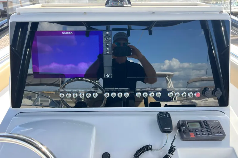 Slide: The Image of 2017 Sportsman Heritage 251 Center Console dashboard with Simrad display and controls. - 7