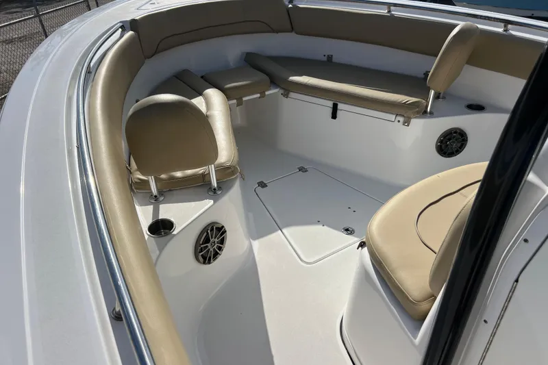 Slide: The Image of 2017 Sportsman Heritage 251 Center Console boat interior with beige seating and cup holders. - 8