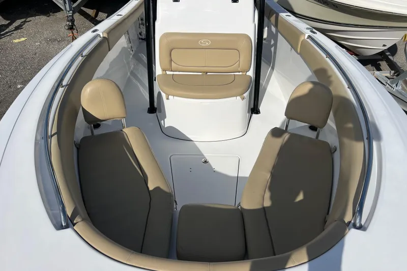 Slide: The Image of 2017 Sportsman Heritage 251 Center Console boat interior with tan seating and white deck. - 9