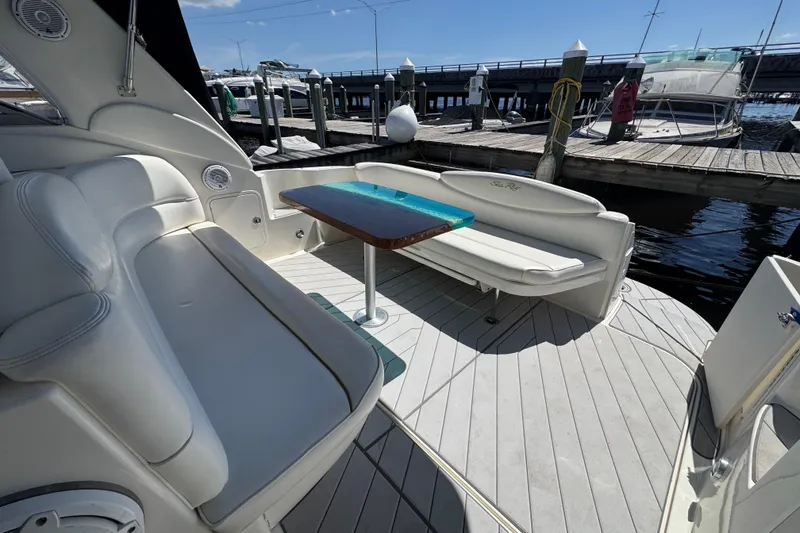 Slide: The Image of Luxurious 2001 Sea Ray 340 Sundancer yacht interior with white seating and a sleek table. - 11