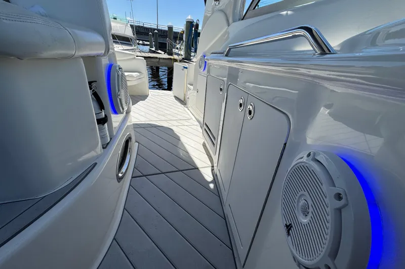 Slide: The Image of 2001 Sea Ray 340 Sundancer boat interior with blue-lit speakers and sleek design. - 15
