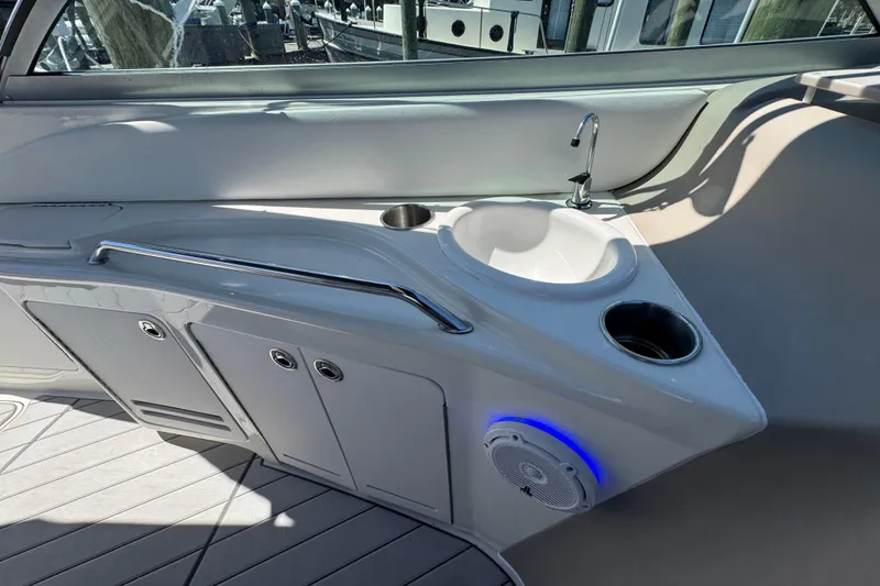 Slide: The Image of 2001 Sea Ray 340 Sundancer boat interior with sink and storage cabinets. - 16