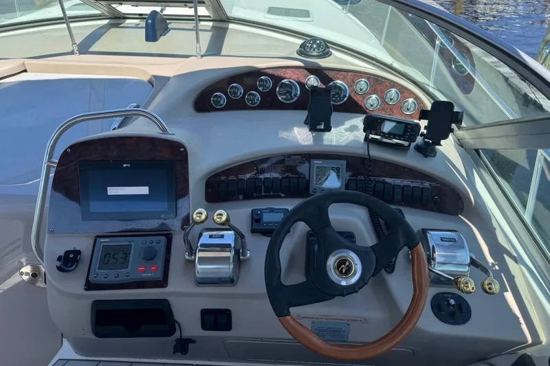 Slide: The Image of Cockpit of 2001 Sea Ray 340 Sundancer with steering wheel and control panel. - 18